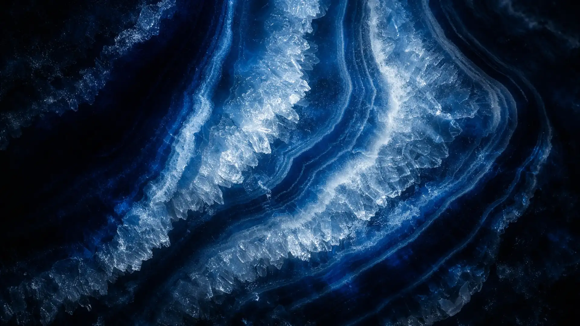 Polished blue agate stone surface with dramatic crystalline banding